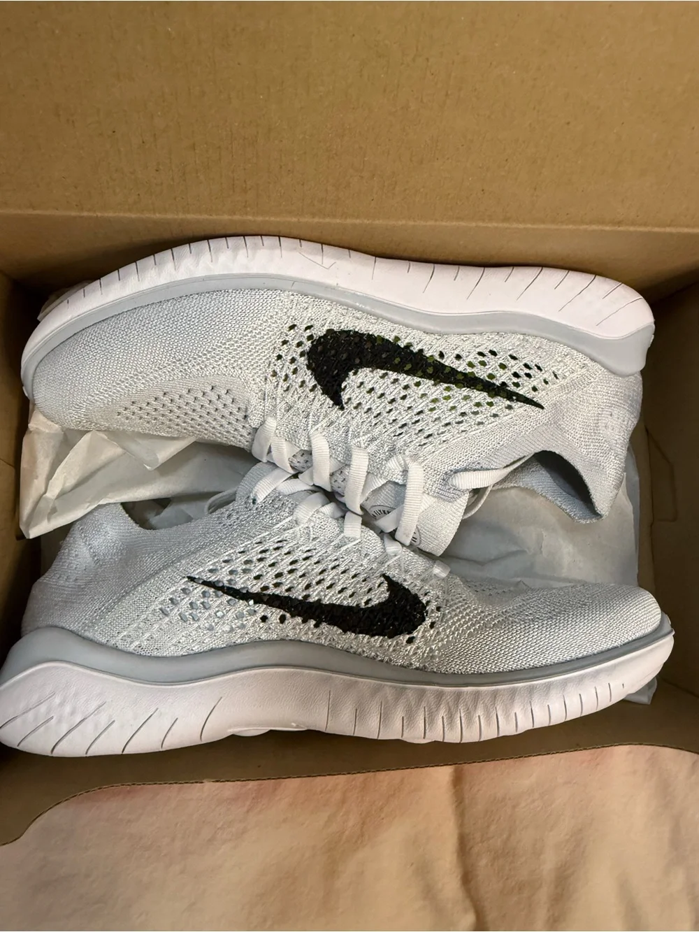 Nike White Flyknit Sneakers with Black Swoosh